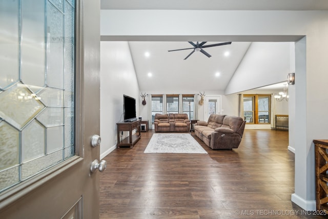 living room featuring high vaulted ceiling, a healthy amount of sunlight, dark hardwood / wood-style floors, and ceiling fan with notable chandelier