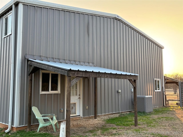 property exterior at dusk featuring central air condition unit