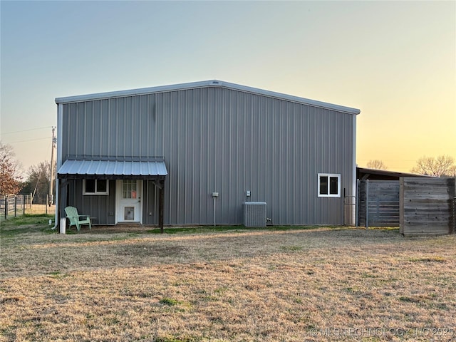 exterior space with a yard and central air condition unit