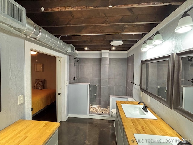 bathroom with vanity, concrete flooring, toilet, and walk in shower