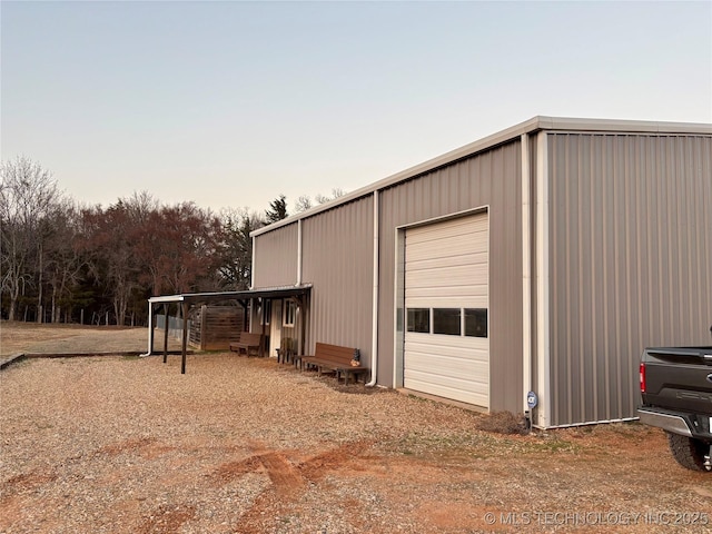 outdoor structure at dusk featuring a garage