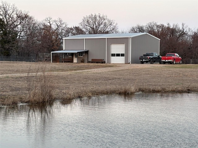 view of outbuilding with a water view and a garage