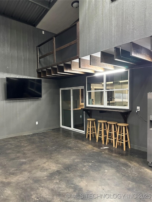 garage with stainless steel refrigerator with ice dispenser