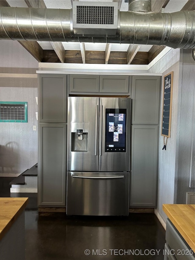 kitchen featuring butcher block counters, gray cabinets, and stainless steel refrigerator with ice dispenser