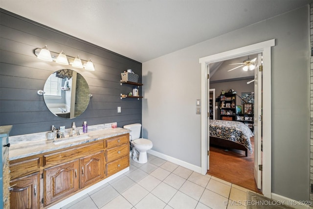 bathroom with tile patterned flooring, vanity, ceiling fan, and toilet