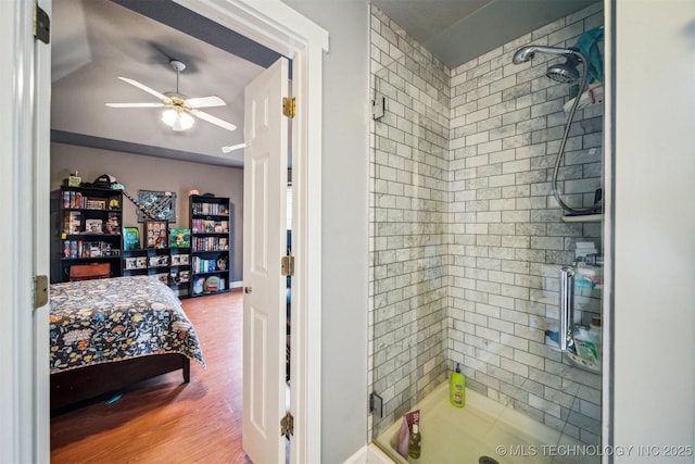 bathroom featuring ceiling fan and tiled shower