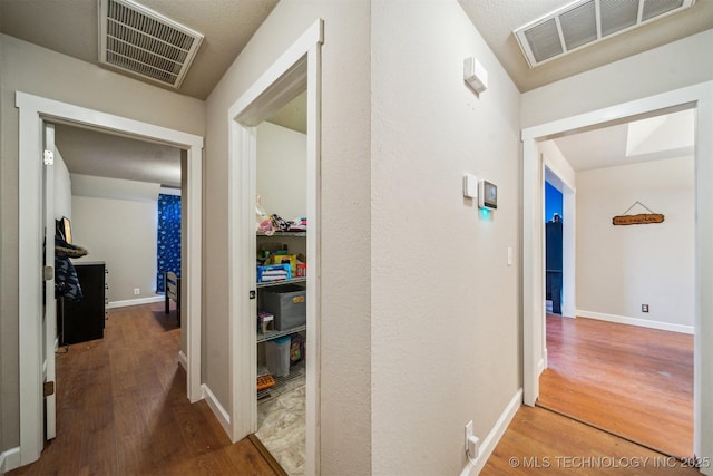 corridor with wood-type flooring