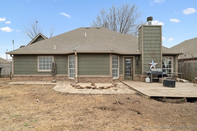 rear view of property with a wooden deck