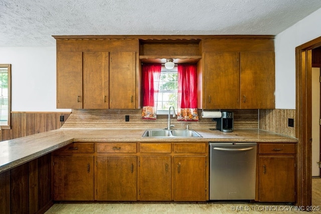 kitchen with dishwasher, sink, and a textured ceiling