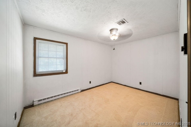 carpeted spare room featuring a baseboard radiator and a textured ceiling