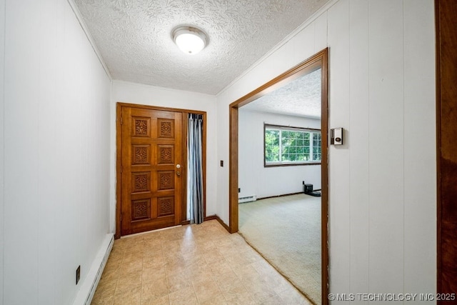 entryway with crown molding, a baseboard radiator, and a textured ceiling