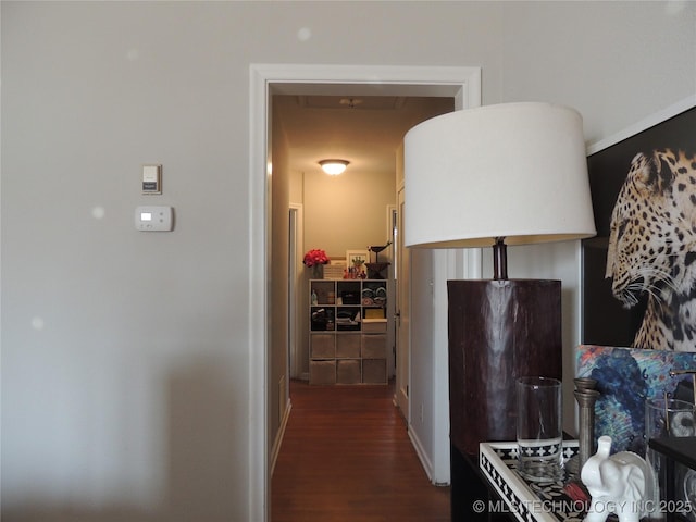 hallway with dark hardwood / wood-style flooring