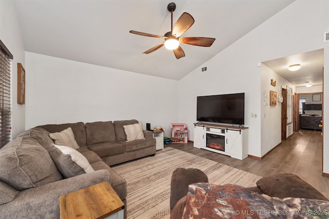 living room featuring vaulted ceiling, hardwood / wood-style floors, and ceiling fan