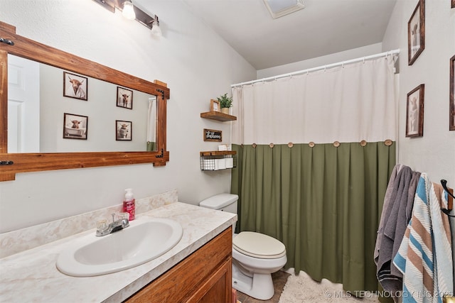 bathroom with vanity and toilet