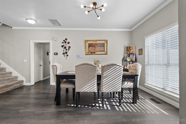 dining room with an inviting chandelier, ornamental molding, and dark wood-type flooring