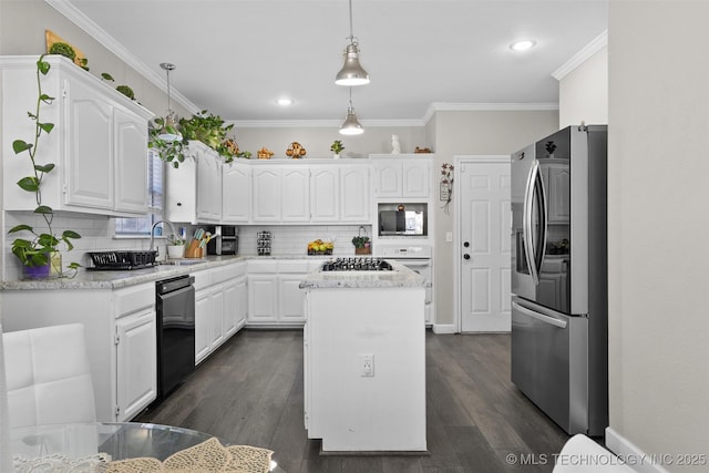 kitchen featuring a kitchen island, appliances with stainless steel finishes, hanging light fixtures, and white cabinets