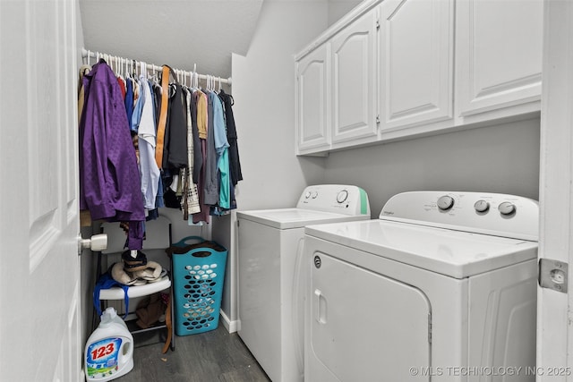 laundry area featuring cabinets, dark hardwood / wood-style flooring, and washing machine and dryer