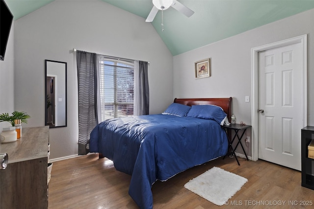 bedroom with ceiling fan, wood-type flooring, and vaulted ceiling