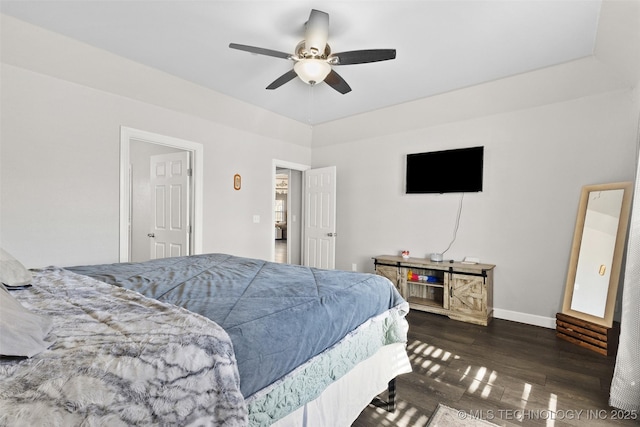 bedroom with dark hardwood / wood-style floors and ceiling fan