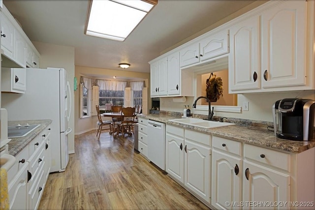 kitchen with sink, white cabinetry, electric cooktop, light hardwood / wood-style flooring, and white dishwasher