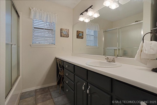 bathroom featuring enclosed tub / shower combo and vanity