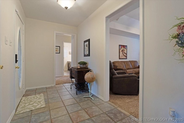 hall with light colored carpet