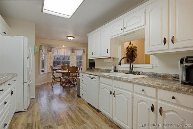 kitchen with sink, white cabinets, white appliances, and light hardwood / wood-style flooring