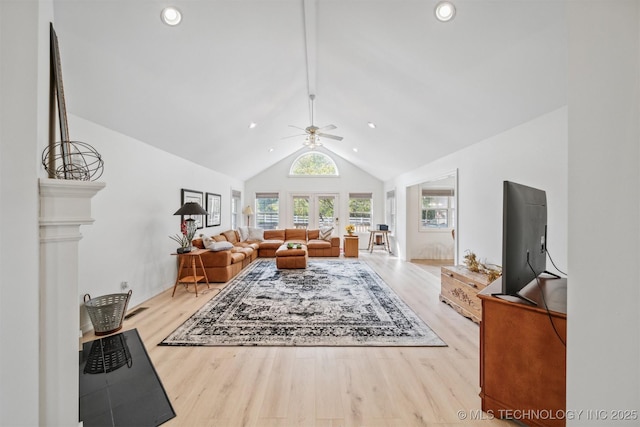 living room featuring high vaulted ceiling, ceiling fan, and light wood-type flooring