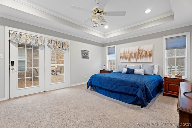 bedroom with ceiling fan, ornamental molding, a raised ceiling, and carpet