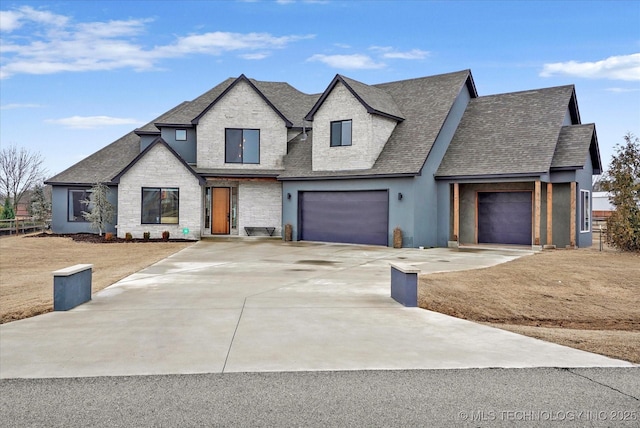 french country style house with a garage