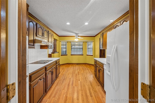 kitchen featuring crown molding, white refrigerator with ice dispenser, light hardwood / wood-style floors, a textured ceiling, and black electric cooktop