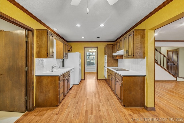 kitchen featuring crown molding, white appliances, and light hardwood / wood-style floors