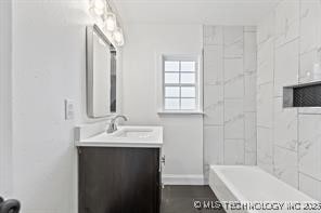 bathroom with vanity and a washtub