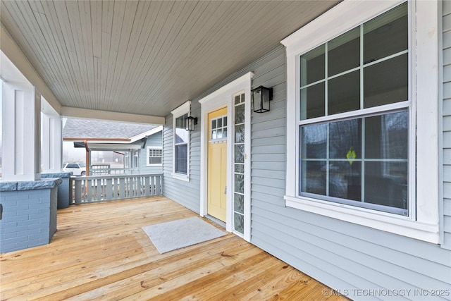 wooden terrace featuring covered porch