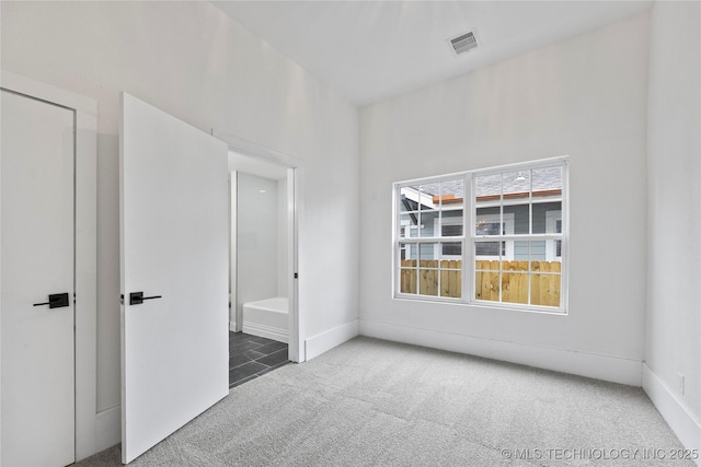 empty room with dark colored carpet