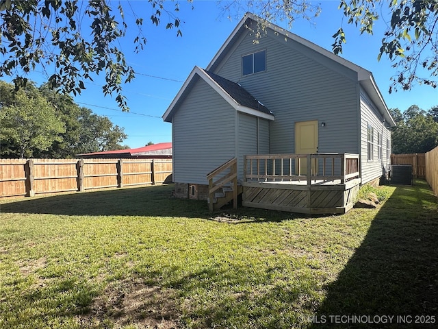 back of house with a wooden deck, a lawn, and cooling unit