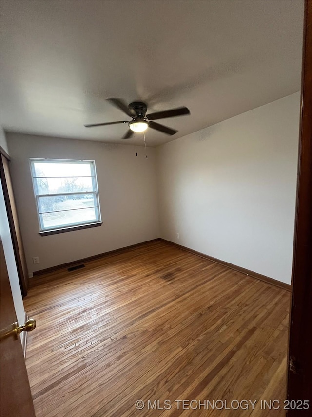 503 Parkview Dr, Bartlesville, OK 74003 - empty room featuring wood finished floors, ceiling fan, and baseboards