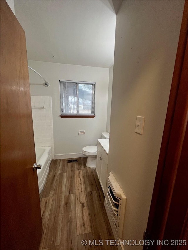 503 Parkview Dr, Bartlesville, OK 74003 - full bath featuring wood finished floors, baseboards, toilet, vanity, and an AC wall unit