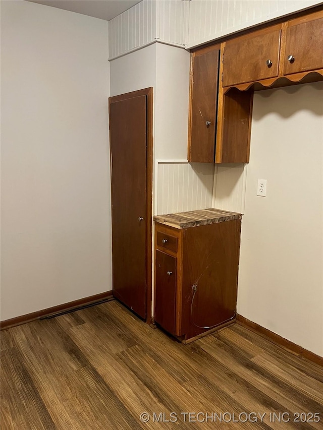 503 Parkview Dr, Bartlesville, OK 74003 - kitchen with dark wood finished floors, baseboards, and brown cabinets