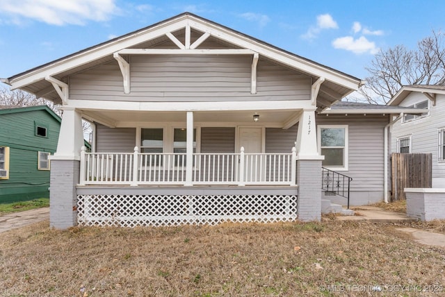 view of front of house with a porch and a front lawn