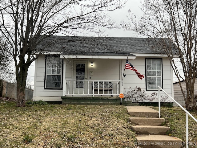 view of front of house featuring a front yard and covered porch