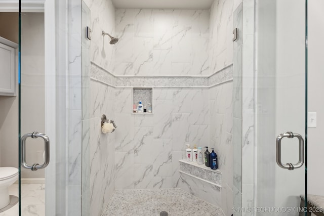 bathroom featuring a stall shower, marble finish floor, and toilet