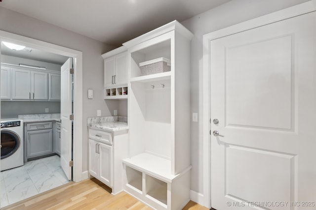 mudroom featuring washer / clothes dryer and marble finish floor