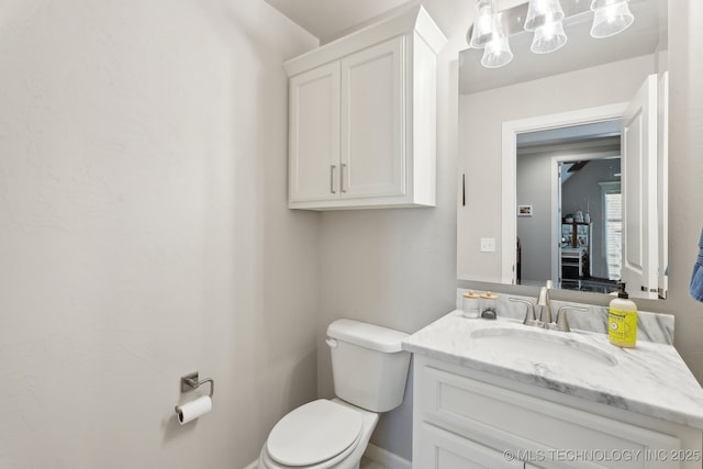 half bathroom with toilet and vanity