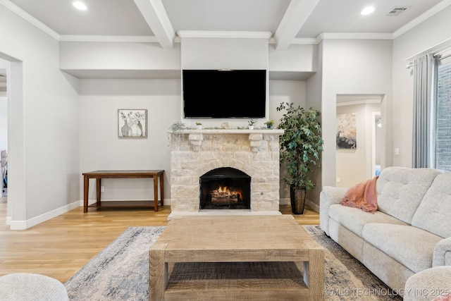 living room with light wood finished floors, beam ceiling, visible vents, and crown molding