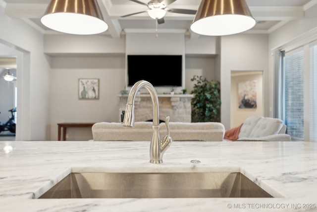 interior space featuring light countertops, a fireplace, a sink, and a ceiling fan