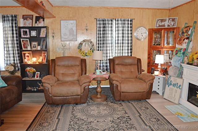 living room with ornamental molding and light wood-type flooring
