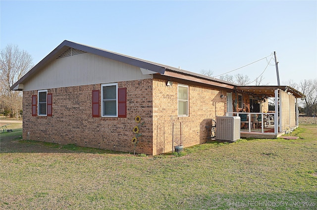 view of property exterior featuring a lawn and central air condition unit