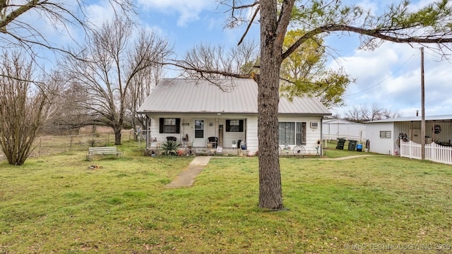 rear view of house featuring a lawn and a porch