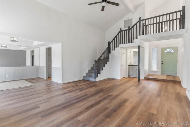 interior space with beamed ceiling, ceiling fan, wood-type flooring, and high vaulted ceiling